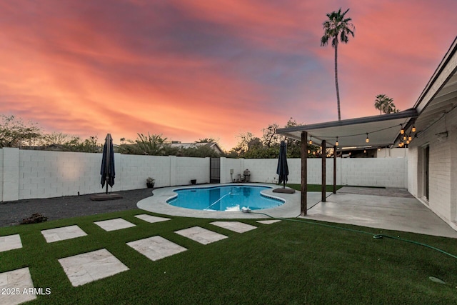 view of pool with a fenced in pool, a patio, a lawn, and a fenced backyard