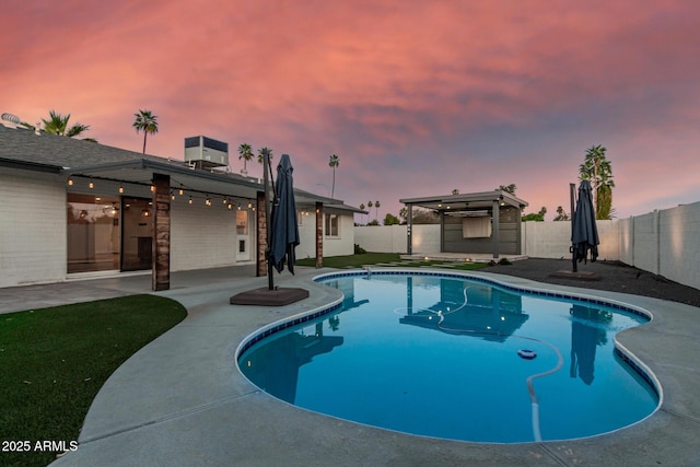 view of swimming pool featuring a fenced in pool, a patio, and a fenced backyard