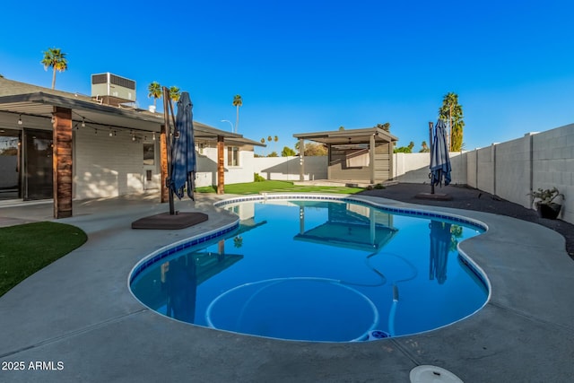 view of pool with an outbuilding, central AC unit, a fenced in pool, a fenced backyard, and a patio area