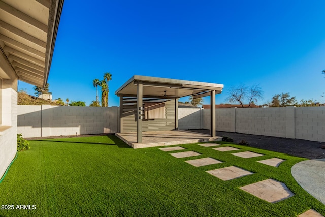 view of yard featuring an outdoor structure and a fenced backyard