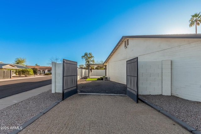 view of gate with fence