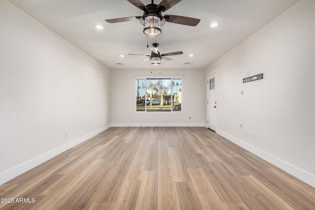 unfurnished room featuring recessed lighting, light wood-style floors, and baseboards