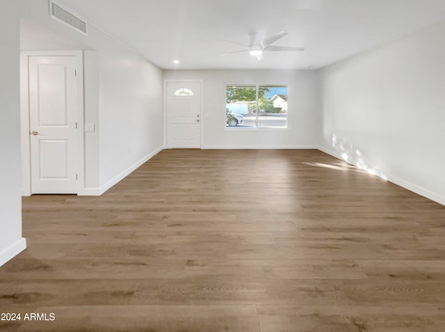 unfurnished room featuring hardwood / wood-style floors and ceiling fan