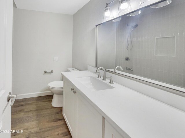 bathroom featuring vanity, toilet, and hardwood / wood-style flooring