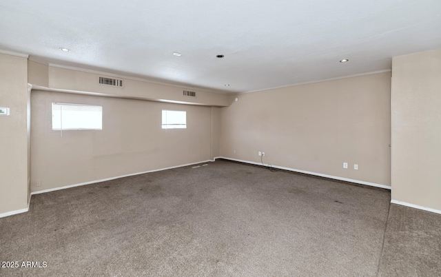 unfurnished room with visible vents, ornamental molding, baseboards, and carpet floors