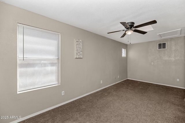 empty room featuring a ceiling fan, baseboards, visible vents, and carpet