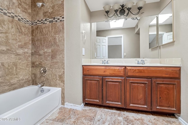 bathroom featuring double vanity, baseboards, shower / bathing tub combination, a sink, and a skylight