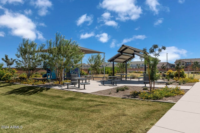 view of property's community with a lawn and a patio area