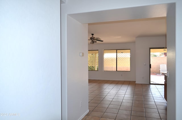 unfurnished room with tile patterned flooring and ceiling fan