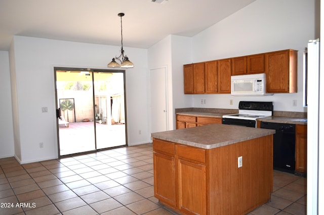 kitchen featuring white appliances, vaulted ceiling, decorative light fixtures, an inviting chandelier, and a kitchen island