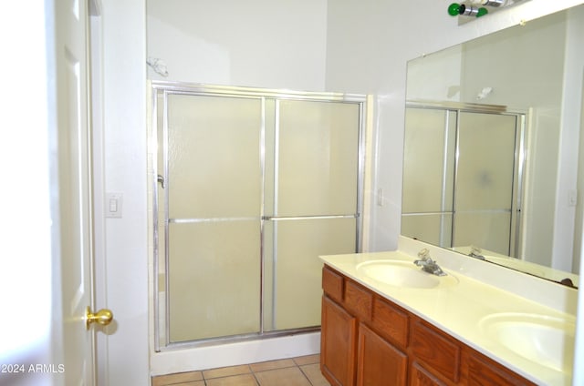 bathroom featuring vanity, tile patterned floors, and walk in shower