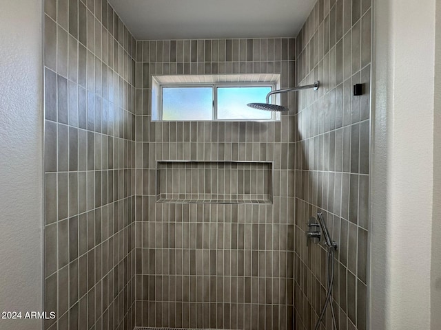 bathroom with tiled shower