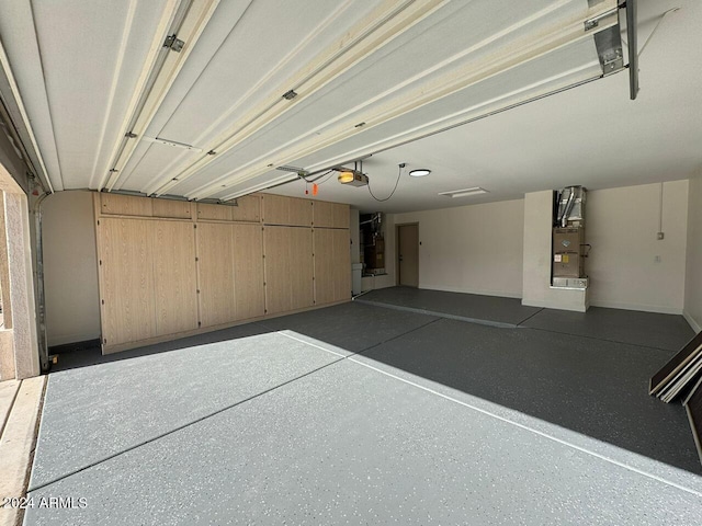 garage featuring heating unit and a garage door opener