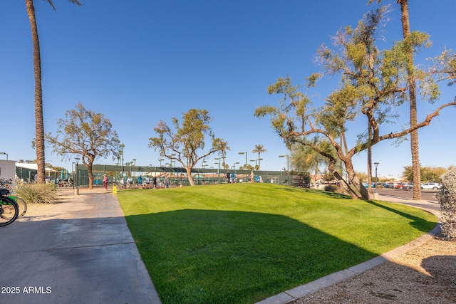 surrounding community featuring a yard and fence