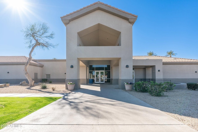 view of front of home with french doors and stucco siding