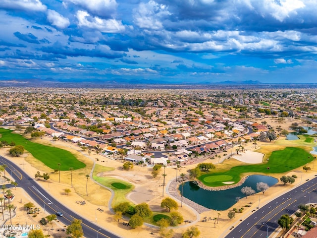 drone / aerial view with view of golf course, a water view, and a residential view