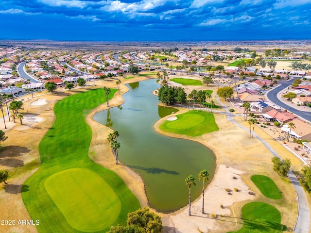 aerial view with a residential view, view of golf course, and a water view