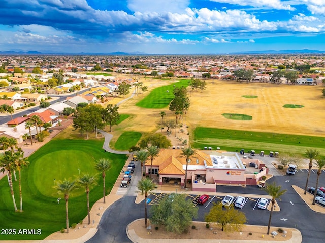 drone / aerial view with view of golf course and a residential view