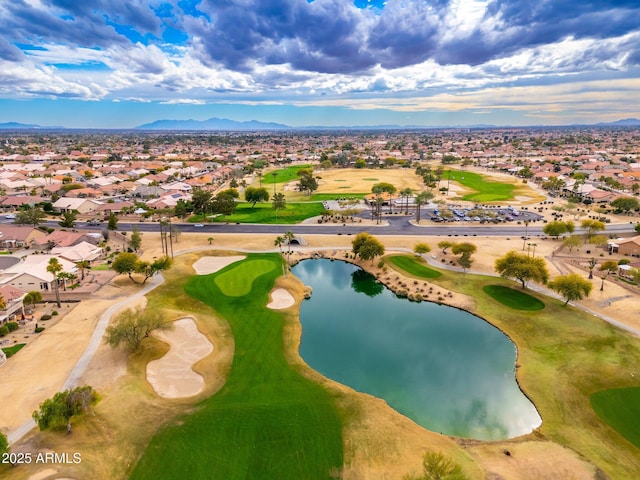 drone / aerial view featuring a residential view, golf course view, and a water and mountain view