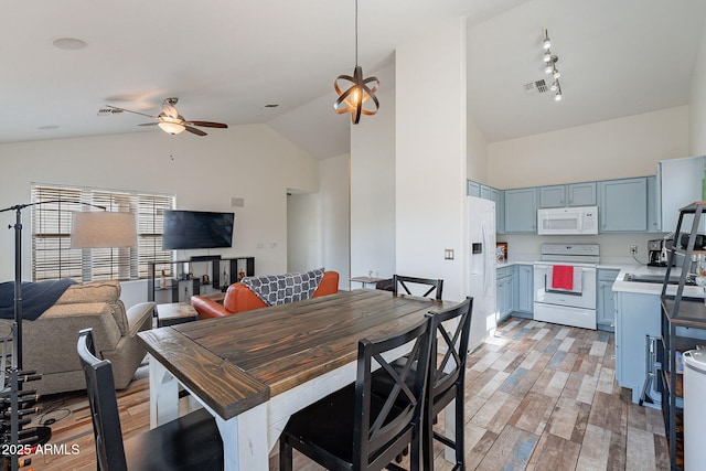 2731 E Windsor Ave, Phoenix, AZ 85008 - dining room featuring ceiling fan, light wood-style floors, and high vaulted ceiling
