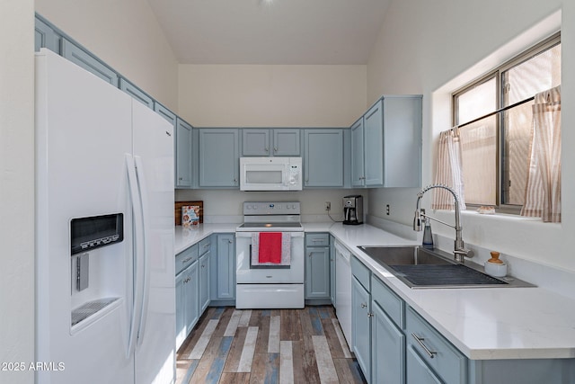 2731 E Windsor Ave, Phoenix, AZ 85008 - kitchen featuring white appliances, a sink, wood finished floors, and blue cabinets
