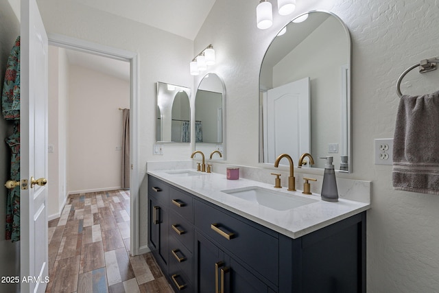 2731 E Windsor Ave, Phoenix, AZ 85008 - bathroom featuring double vanity, wood finished floors, and a textured wall