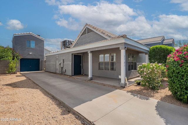 2731 E Windsor Ave, Phoenix, AZ 85008 - view of front of home with stucco siding, driveway, a porch, an attached garage, and a tiled roof