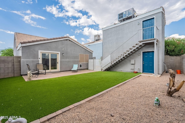 2731 E Windsor Ave, Phoenix, AZ 85008 - rear view of house featuring a patio, stairway, stucco siding, and a tiled roof