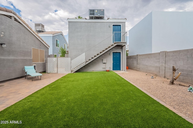 2731 E Windsor Ave, Phoenix, AZ 85008 - back of property with stairway, a patio, central air condition unit, and stucco siding