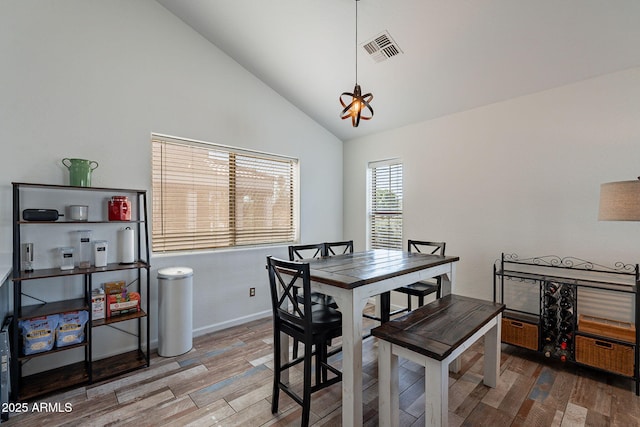 2731 E Windsor Ave, Phoenix, AZ 85008 - dining area featuring wood finished floors, baseboards, and high vaulted ceiling