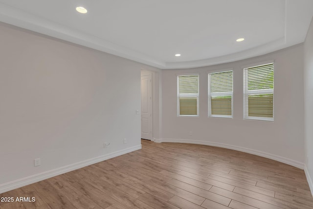 4853 N 183rd Ln, Goodyear, AZ 85395 - empty room featuring baseboards, light wood-style floors, recessed lighting, and a tray ceiling