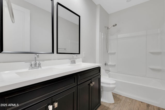 4853 N 183rd Ln, Goodyear, AZ 85395 - full bathroom with toilet, double vanity, wood finished floors, and tub / shower combination