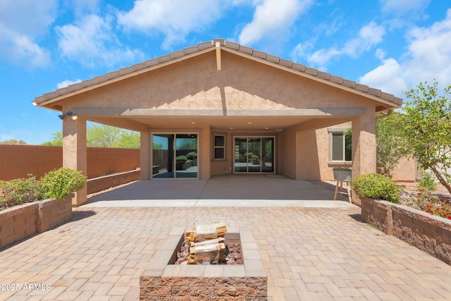 4853 N 183rd Ln, Goodyear, AZ 85395 - rear view of house with a patio area, stucco siding, and a fire pit