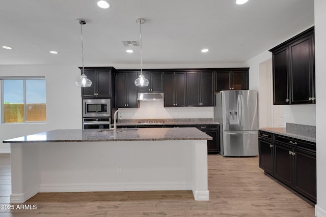 4853 N 183rd Ln, Goodyear, AZ 85395 - kitchen with appliances with stainless steel finishes, a sink, under cabinet range hood, light stone countertops, and light wood-type flooring