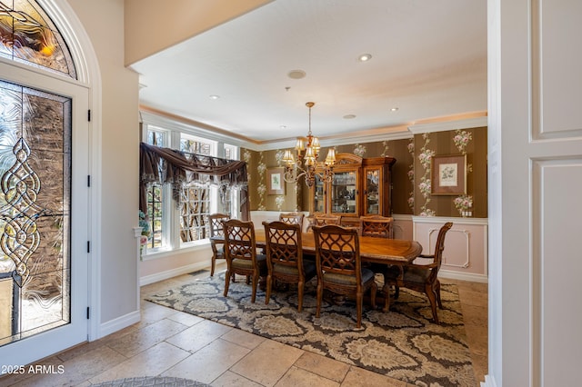 dining space with ornamental molding, stone tile flooring, recessed lighting, an inviting chandelier, and baseboards