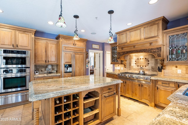 kitchen with light stone counters, a kitchen island, stainless steel appliances, and a warming drawer