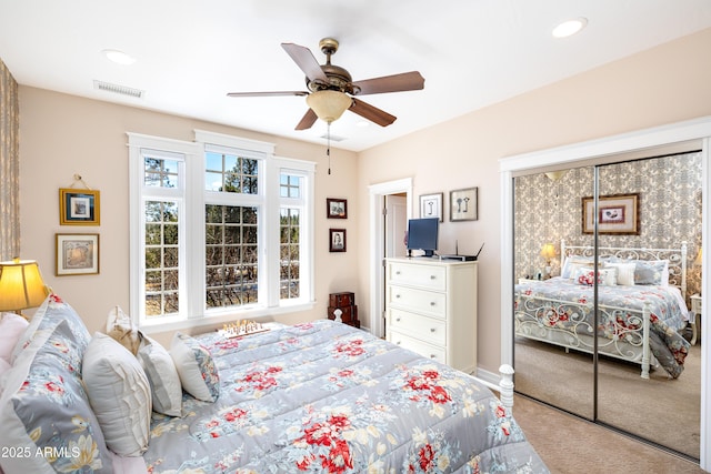 carpeted bedroom with a closet, visible vents, recessed lighting, and ceiling fan