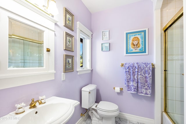 bathroom featuring a sink, baseboards, and toilet