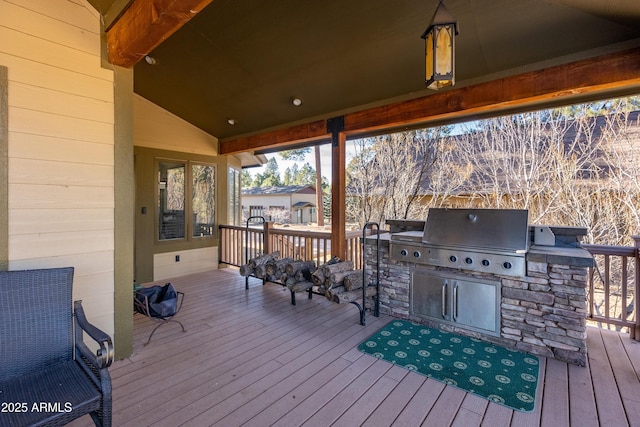 wooden deck with grilling area and an outdoor kitchen