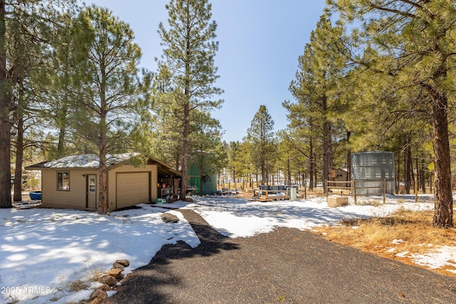 snowy yard with an outdoor structure and a garage