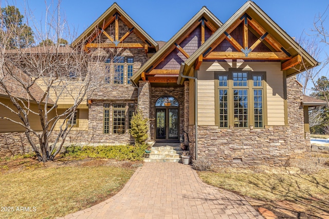 craftsman inspired home featuring french doors and stone siding
