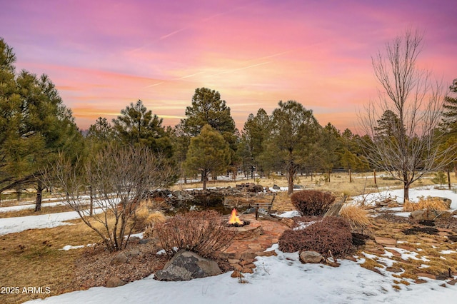 snowy yard featuring an outdoor fire pit