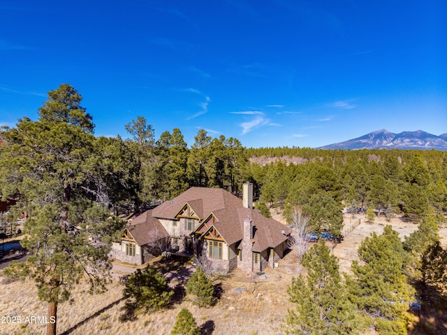 drone / aerial view featuring a forest view and a mountain view