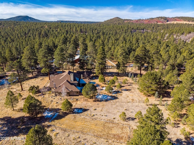 drone / aerial view with a mountain view and a wooded view