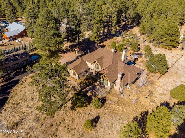 birds eye view of property with a view of trees