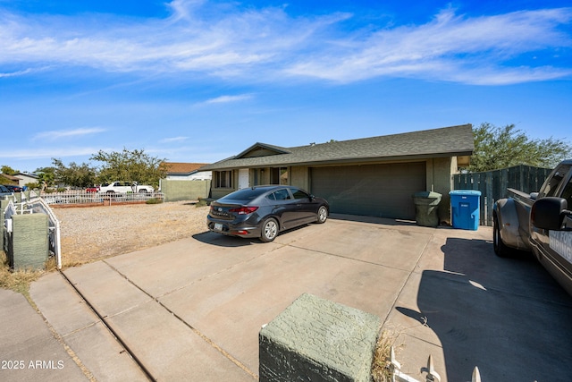 6171 W Mckinley St, Phoenix, AZ 85043 - view of front facade with roof with shingles, driveway, fence, and an attached garage