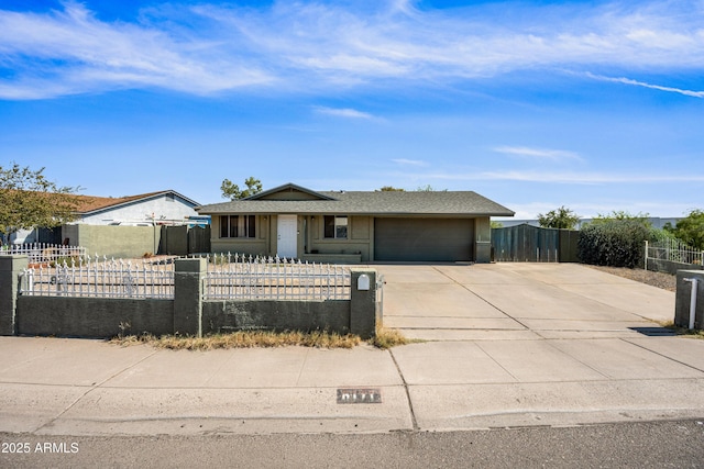 6171 W Mckinley St, Phoenix, AZ 85043 - view of front facade with concrete driveway, an attached garage, and a fenced front yard