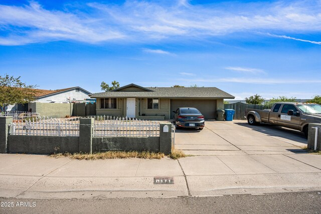 6171 W Mckinley St, Phoenix, AZ 85043 - view of front of house featuring driveway, an attached garage, and a fenced front yard