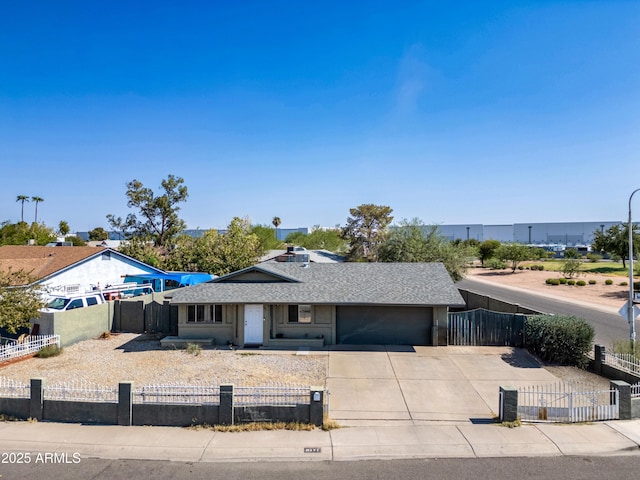 6171 W Mckinley St, Phoenix, AZ 85043 - ranch-style home featuring driveway, a shingled roof, a garage, and a fenced front yard