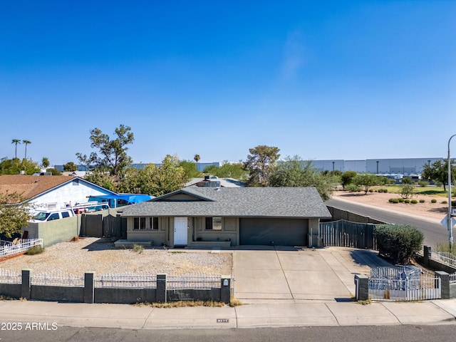 6171 W Mckinley St, Phoenix, AZ 85043 - single story home featuring an attached garage, roof with shingles, a fenced front yard, and concrete driveway
